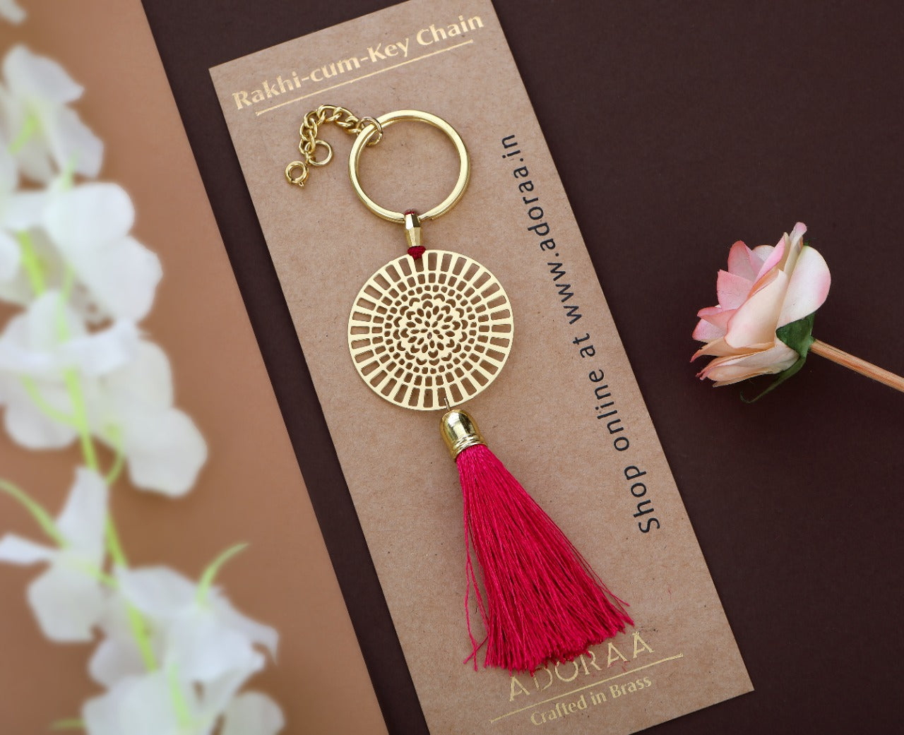 Dial design Rakhi with hanging tassel for bhabhi cum keychain ring crafted in brass with golden finish