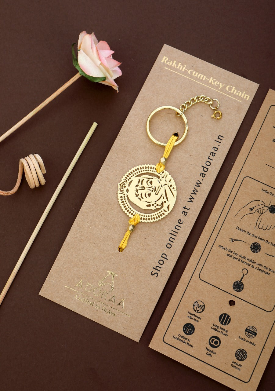ADORAA's Krishna design Rakhi cum keychain ring for Bhai/brother crafted in brass with golden finish
