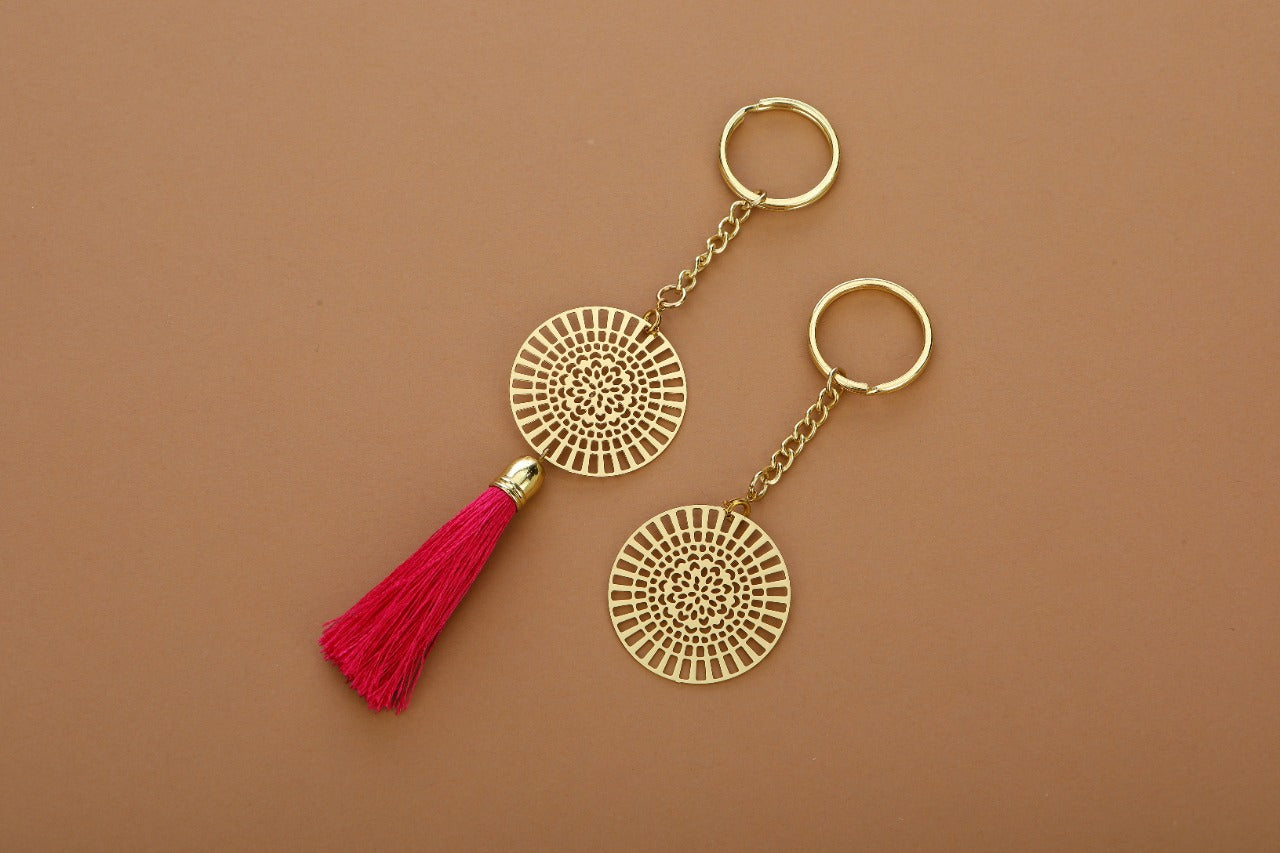 ADORAA's Dial design Rakhi with hanging tassel for bhabi cum keychain ring crafted in brass with golden finish